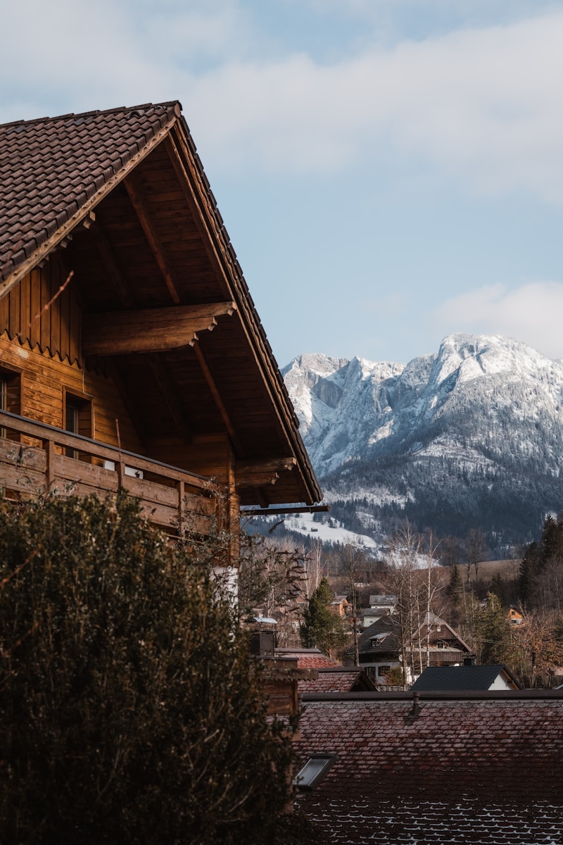Photo by Ahmet Yüksek ✪ Cozy wooden cabin with mountains in the background.